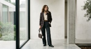 A high-end editorial fashion shot of a stylish woman wearing a curated, chic vintage outfit from a t